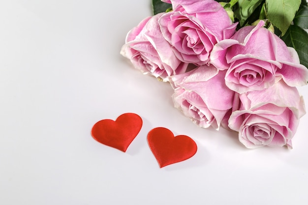 bouquet of roses and hearts on a white background. valentine's day card or banner.