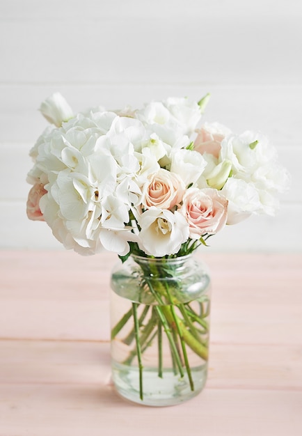 Bouquet of roses and hydrangeas on table