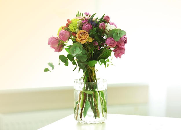 Bouquet of roses in jar on the table