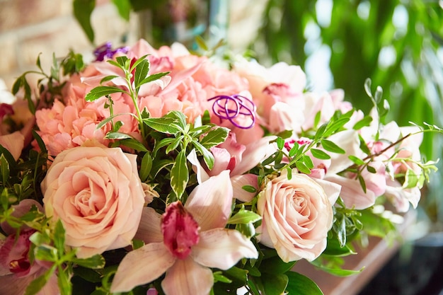 Bouquet of roses, lilies and ruskus close-up.