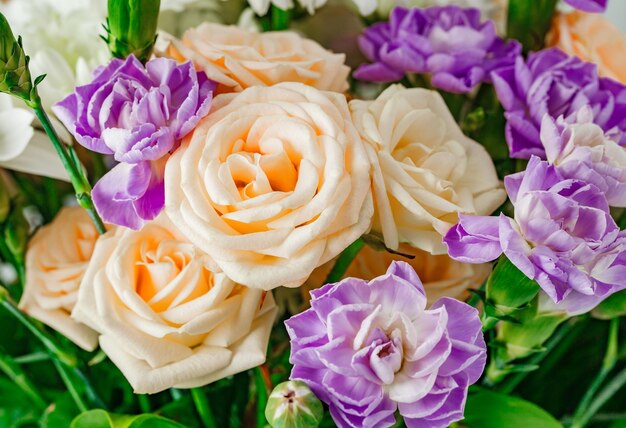 Bouquet of roses and purple flowers closeup