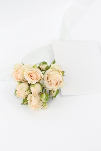 Bouquet roses with invitation card and ribbon