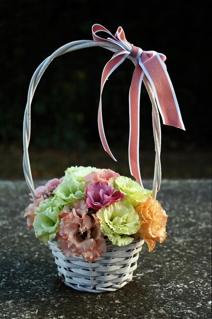 Bouquet of seasonal flowers in a basket with ribbon