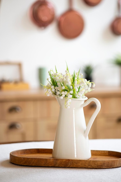 Photo bouquet of spring flowers in a vase on the kitchen table light style mothers day march 8