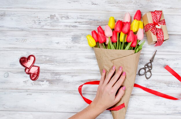 Bouquet of spring tulips and gift 