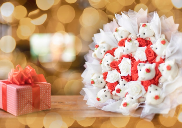 A bouquet of stuffed toys with a gift box on a background with bokeh Selective focus