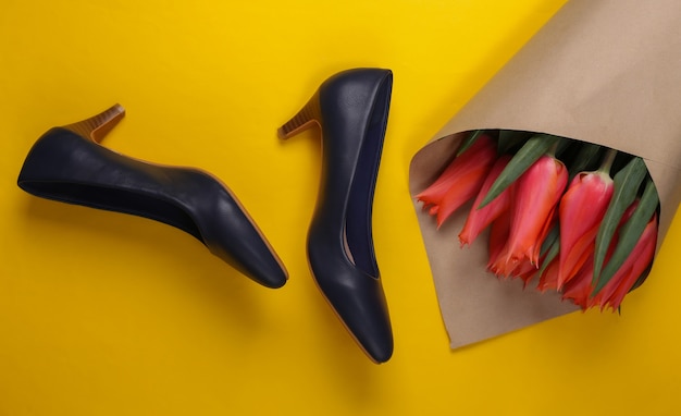 Bouquet of tulips, high-heeled shoes on yellow