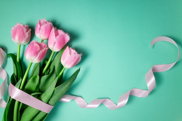 Bouquet of tulips spring flowers on color festive background