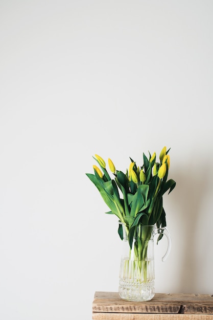 Bouquet of tulips in vase over white background