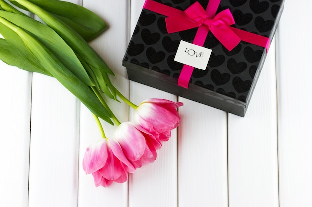 Bouquet of tulips with a gift box