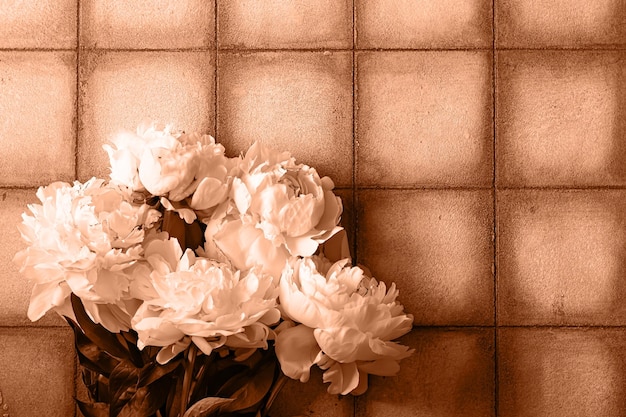 Photo bouquet of white peonies on gray background in the form of tile