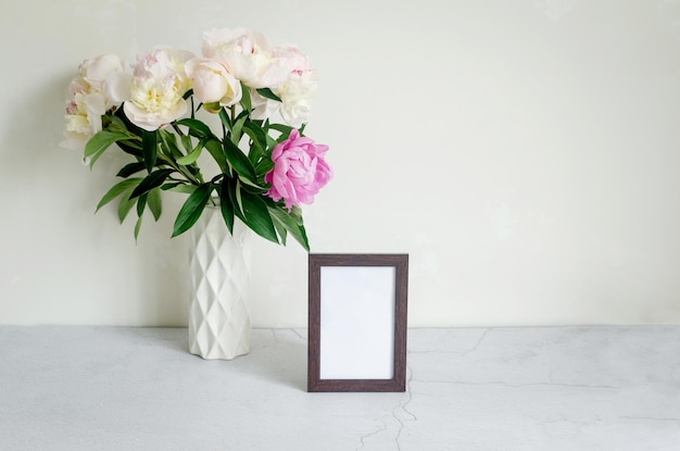 Bouquet of white peonies in a vase on grey background