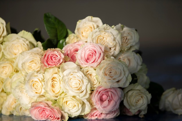 Bouquet of white roses closeup in beige tones