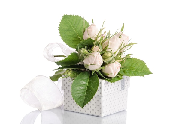 Bouquet of white roses and gift box