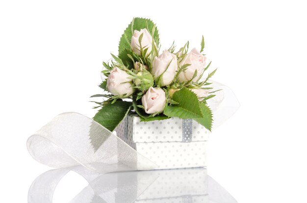 Bouquet of white roses and gift box