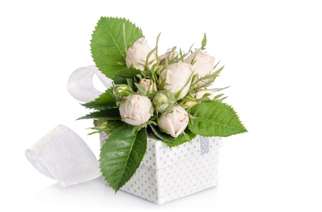 Bouquet of white roses and gift box