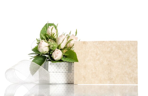 Bouquet of white roses and gift box