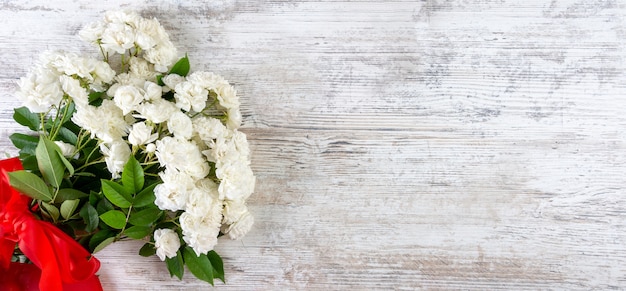 Bouquet of white roses with a red ribbon