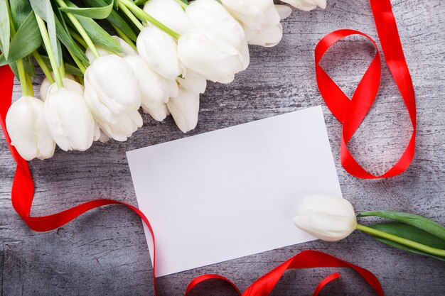 Bouquet white tulips with red ribbon