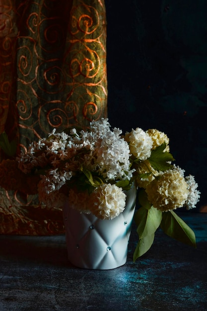 bouquet of white viburnum flowers on a black background
