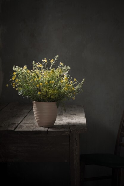 Bouquet of wild flowers on old wooden table