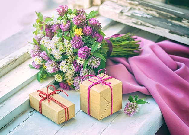 A bouquet of wild flowers and packed gifts on the windowsill.