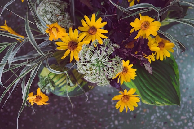 Photo bouquet of wild flowers on the table in the interior