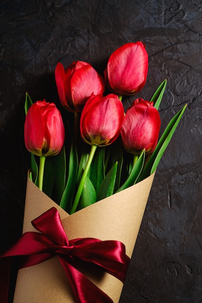 Bouquet with bow-knot ribbon of red tulip flowers