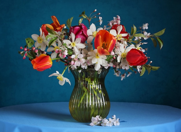 Bouquet with daffodils, tulips and branches of the cherry blossoms.