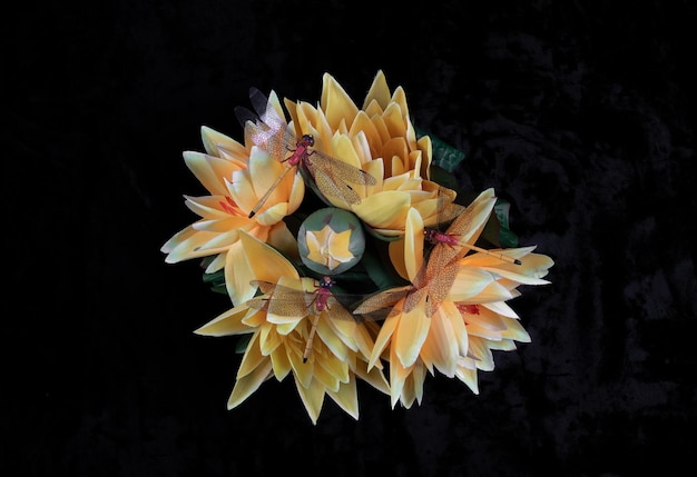 bouquet of yellow artificial flowers on a black background