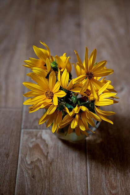 Photo bouquet of yellow flowers on a dark background in grunge style abstract floral arrangement mother's