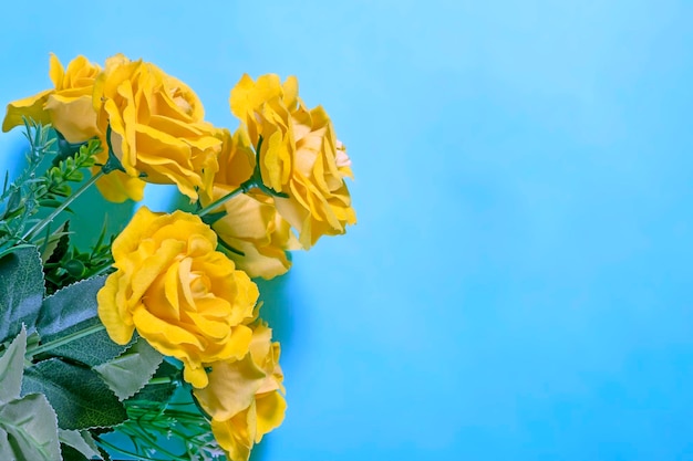 Bouquet of yellow roses on a blue background Place for text