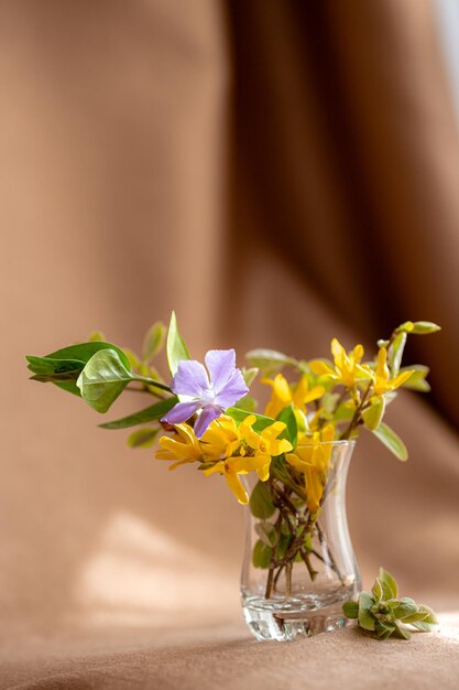 Bouquet of yellow spring flowers in a glass vase