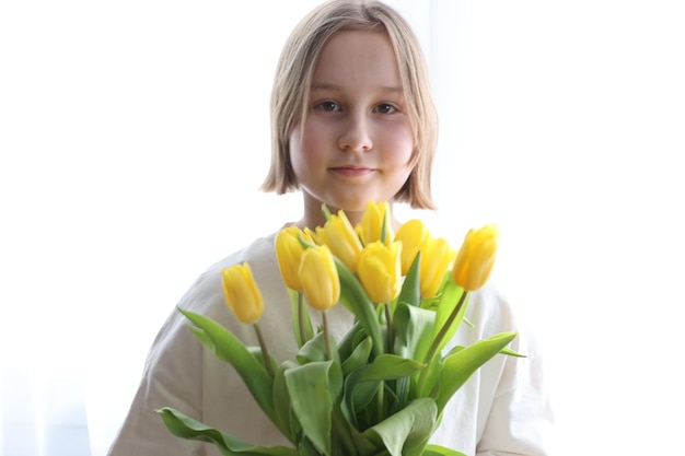 A bouquet of yellow tulips in hand