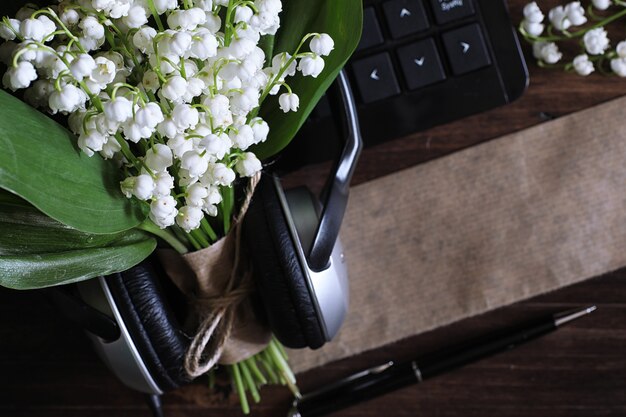 Bouquet of young lilies of the valley on a wooden table