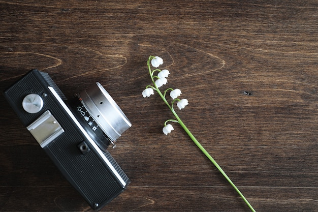 Bouquet of young lilies of the valley on a wooden table