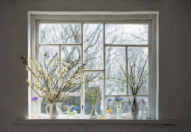 Bouquets of flowers on the windowsill