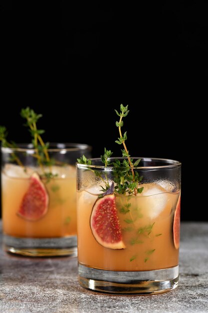 Bourbon Sour cocktail with fig spices lemon juice and syrup Easy to make but so delicious Garnish with figs and thyme