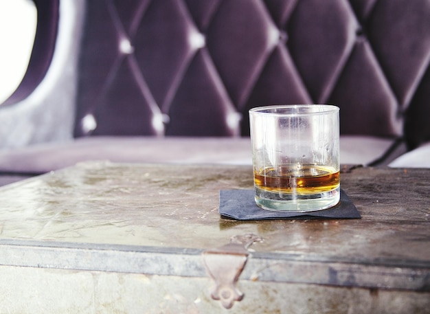 Bourbon whiskey on table by sofa