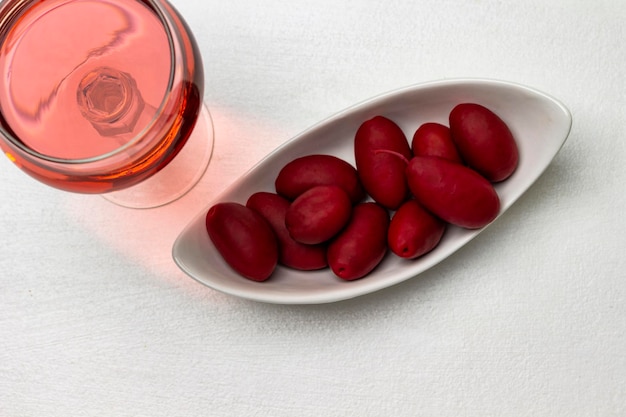 Bourgondische olijven in een wit kom Glas met rose wijn