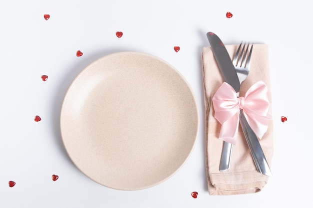 Bovenaanzicht bestek en leeg bord op tafel dienen voor een romantisch diner op Valentijnsdag concept