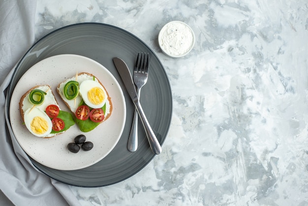 bovenaanzicht smakelijke eiersandwiches met bestek op wit oppervlak hamburger lunch sandwich dieetmaaltijd brood eten gezondheid vrije ruimte