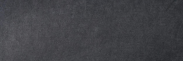 Bovenaanzicht van donker zacht en glad textielmateriaal getextureerde achtergrond natuurlijke zwarte stof