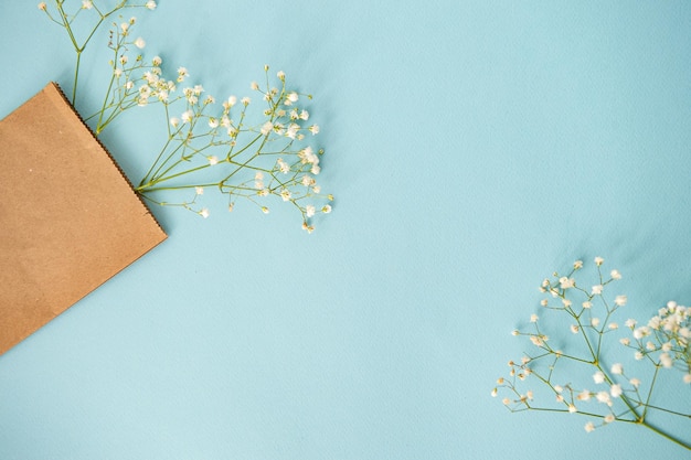 Bovenaanzicht van een blauwe tafel met gipskruidbloemen in een knutselpakket