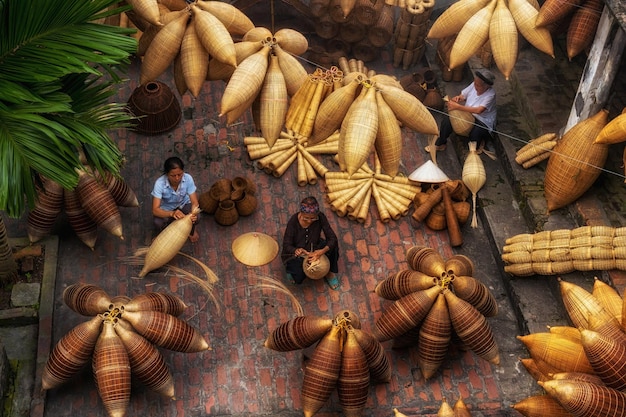 Bovenaanzicht van een groep oude Vietnamese vrouwelijke ambachtsman die de traditionele bamboevis maakt