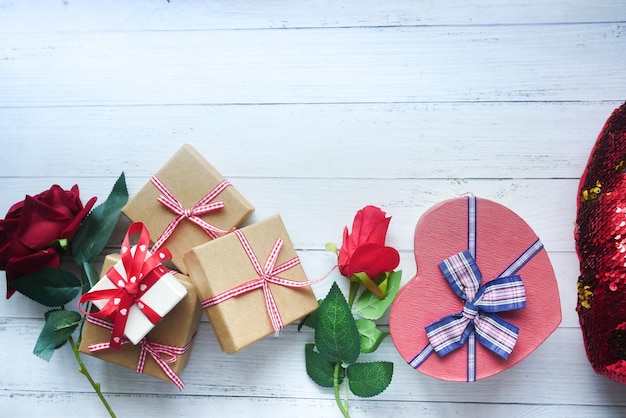 Bovenaanzicht van geschenkdoos en roze bloem op gekleurde achtergrond