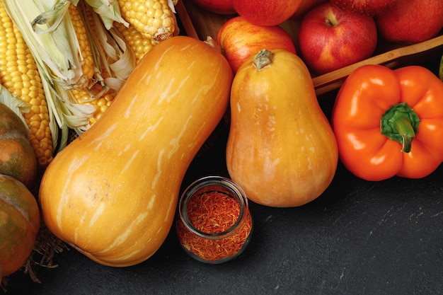 Bovenaanzicht van herfst plantaardige samenstelling met pompoenen en appels op zwart