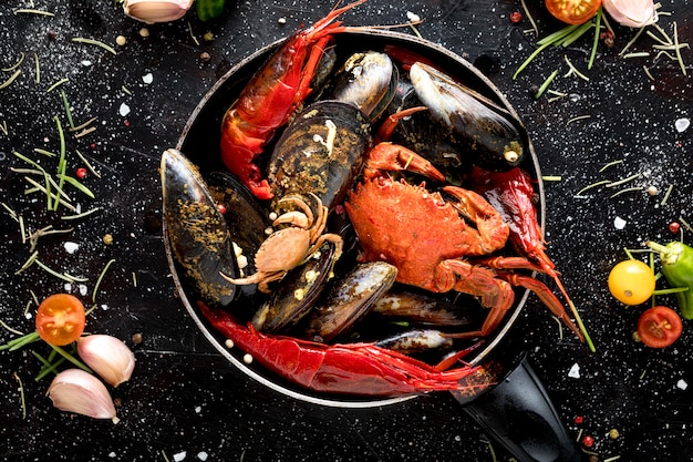 Foto bovenaanzicht van krab en mosselen in pan met garnalen