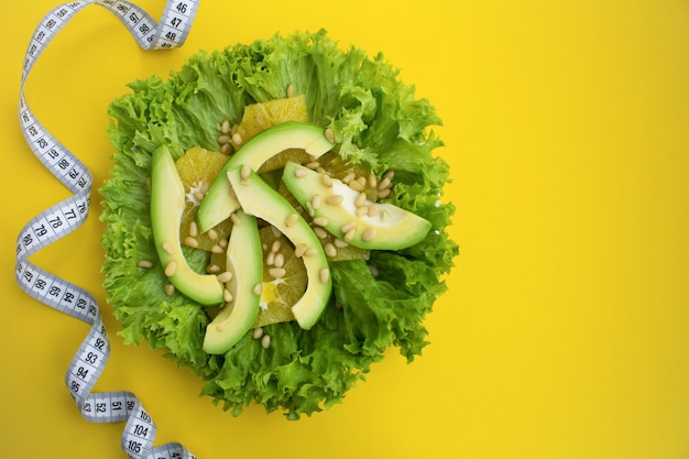 Bovenaanzicht van salade met avocado en witte centimeter