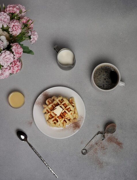 Bovenaanzicht van smakelijke zelfgemaakte wafels plaat op een grijze betonnen achtergrond